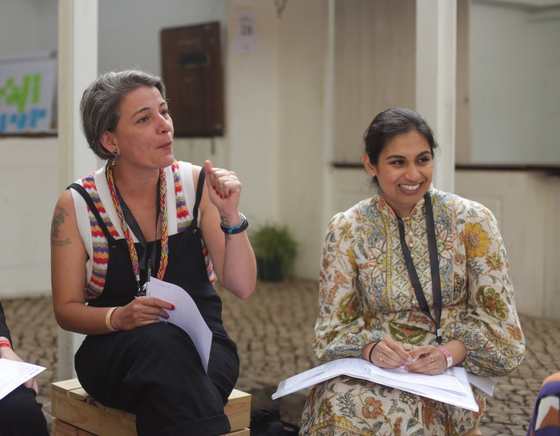 Image shows one participant talking to a group, next to another participant