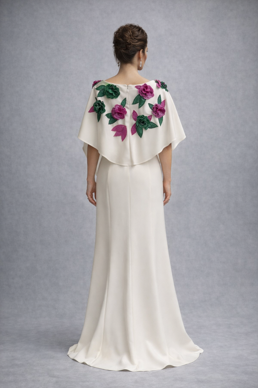 The easiest flowing dress that lightly hugs your sihlouette. This white gown boasts 3D flowers created by hand. The cape creates the perfect modest detail for a mother of the bride or a non-traditional bride. 