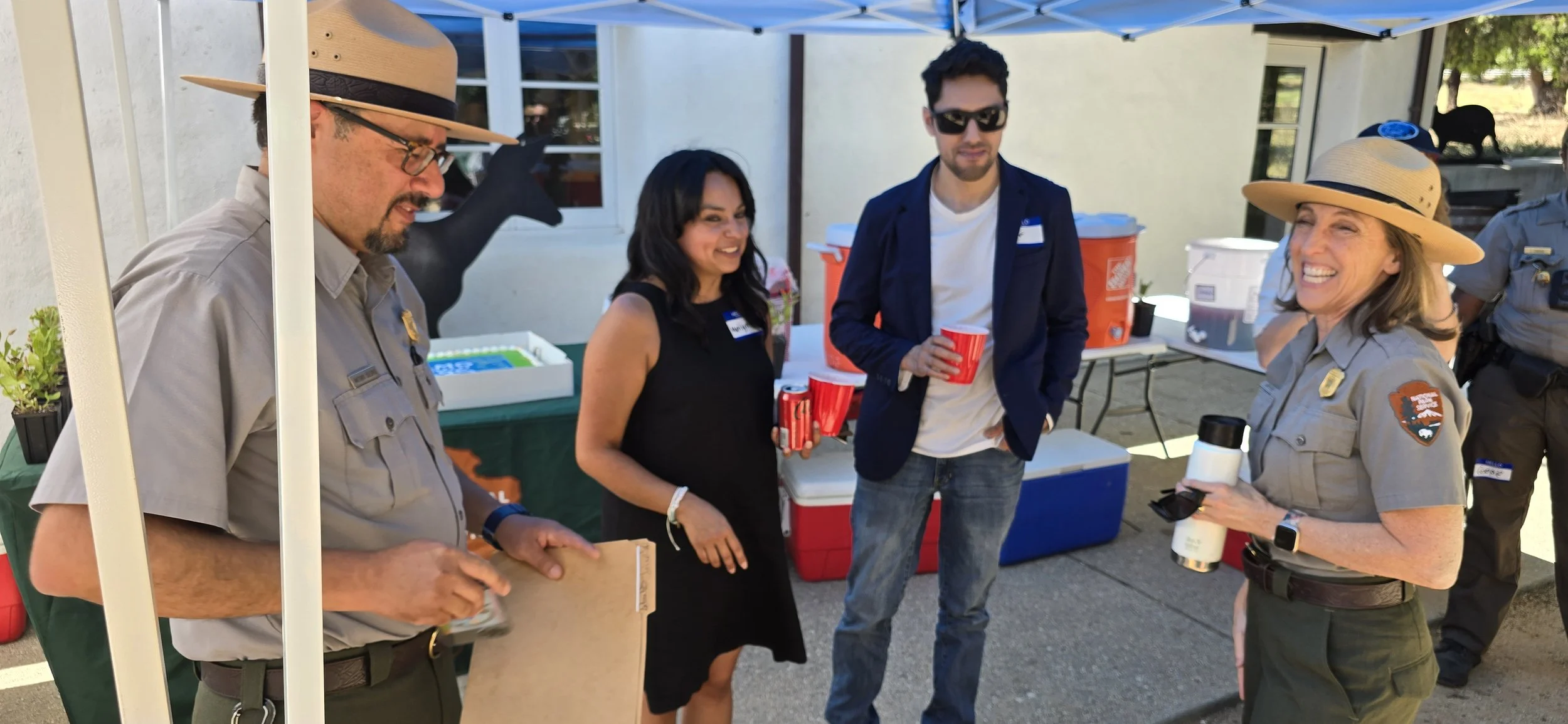 Antonio Solorio, Alum and SAMO Fund Board Member Leenoy Margalit, and Jody Lyle Superintendent of the SMMNRA share memories with a guest at the event.