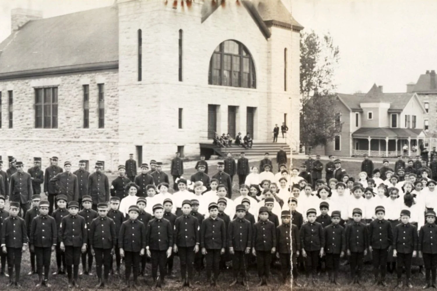 Why were Native American kids required to attend boarding schools?