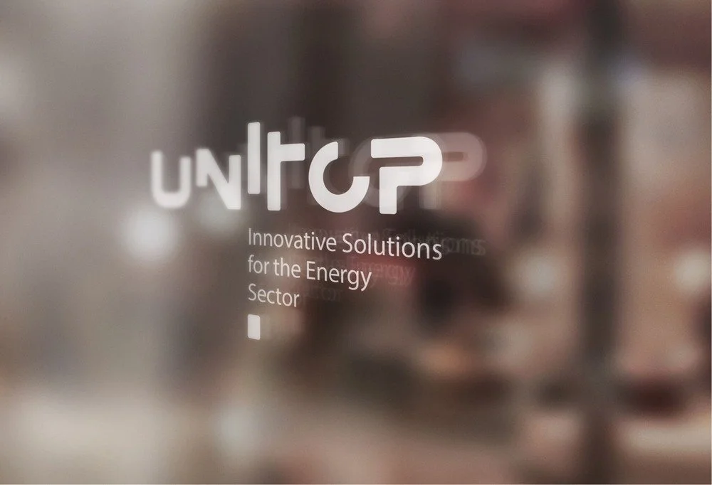 Company logo and tagline on a blurred glass surface reading "UNITOP, Innovative Solutions for the Energy Sector".
