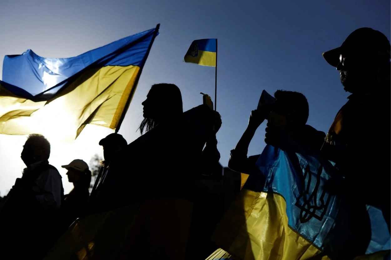 Citizens of Ukraine pictured with their national flag
