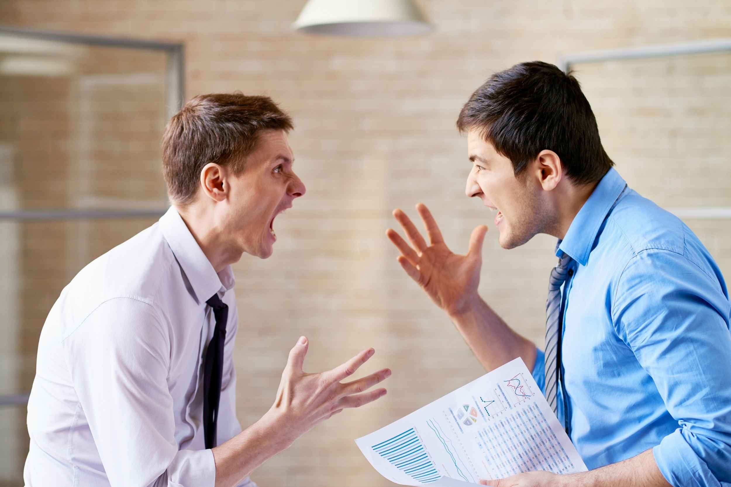Two men are arguing in an office, one is holding a report with data, graphs and pie charts. Both men are gesturing with their hands and it's clear that there is conflict between them