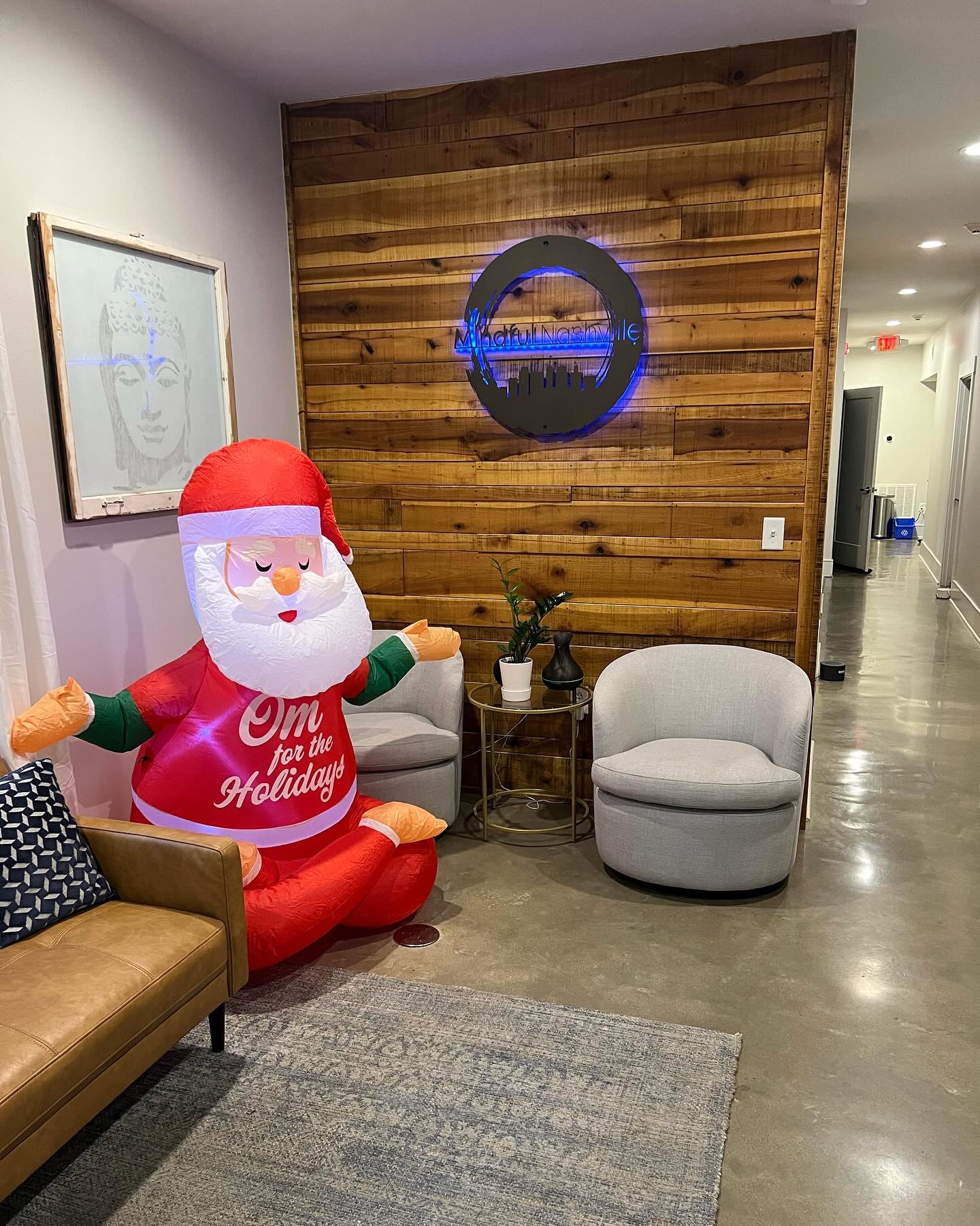Santa is getting his full lotus on, greeting guests in the waiting room. Channeling some Santa yoga vibes. Thank you Juliana for inviting Santa to hang out! Wishing everyone a chill and heart centered weekend ❤️🤗🙏#nashvilleyoga