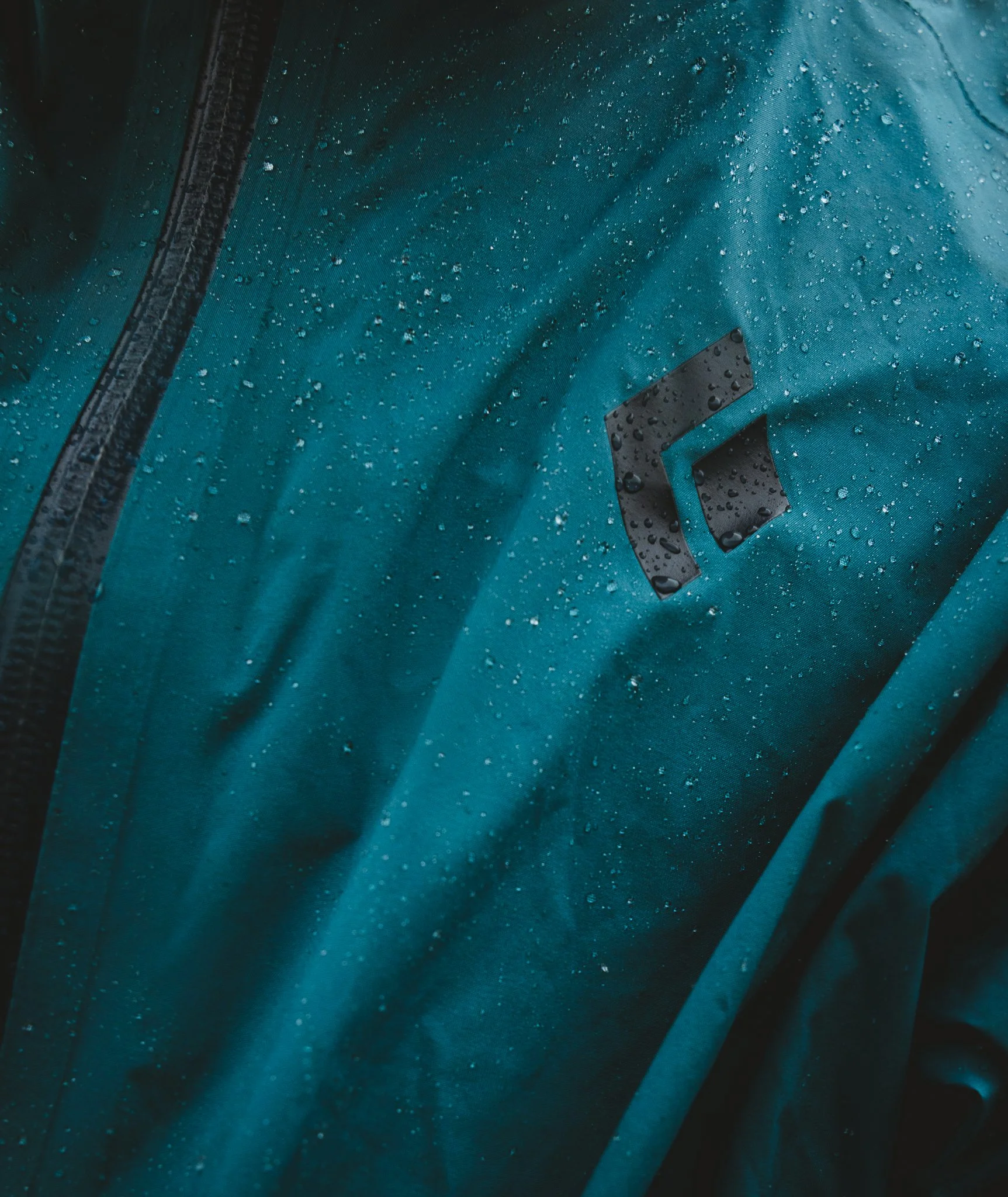 Black Diamond rain jacket protecting from the elements