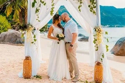 Bride and groom at a tropical beach wedding ceremony overlooking the sea in Seychelles