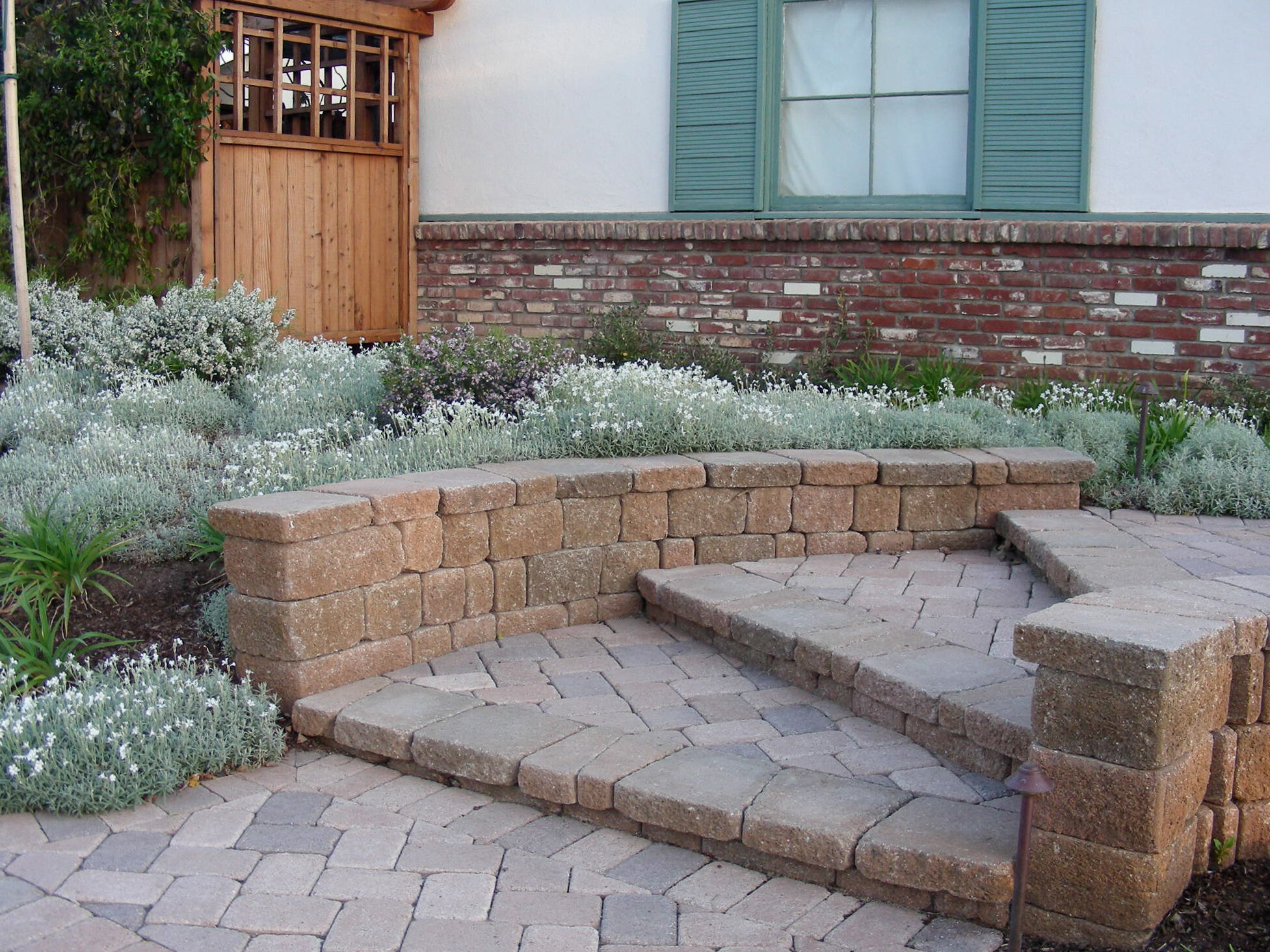 Concrete pavers help with the change in elevation and harmonize with the brick facade.
