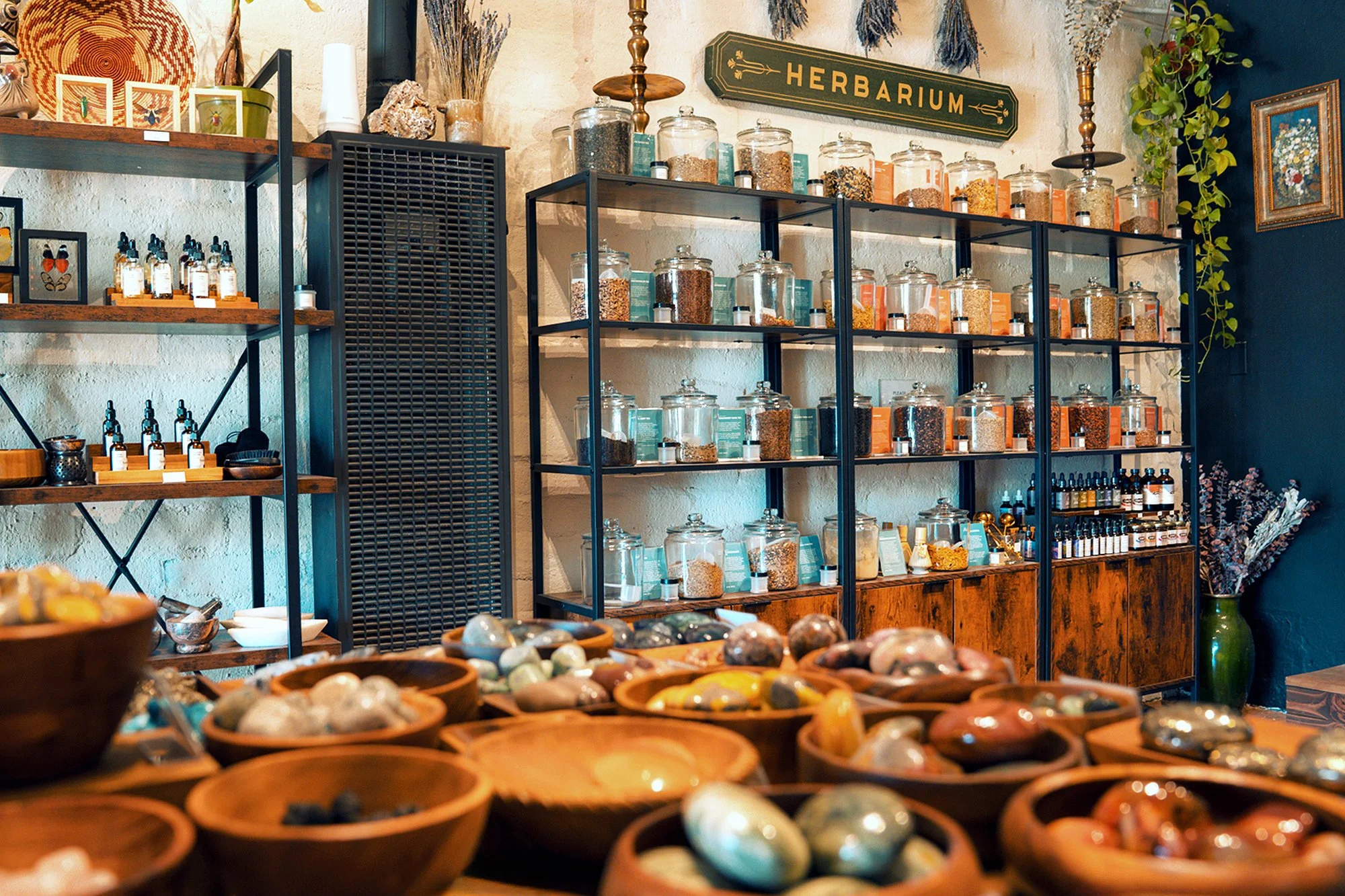 Organic herbs, loose-leaf teas, handcrafted fragrances, and botanical goods displayed inside Mojave Moon Apothecary in Twentynine Palms, California.