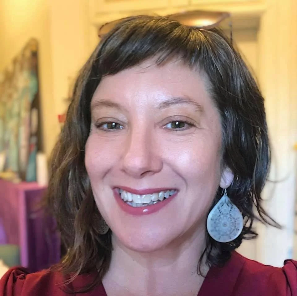 A photo of Tena Moore, Squarespace expert web designer, with short brown hair and hazel-colored eyes smiling into the camera.