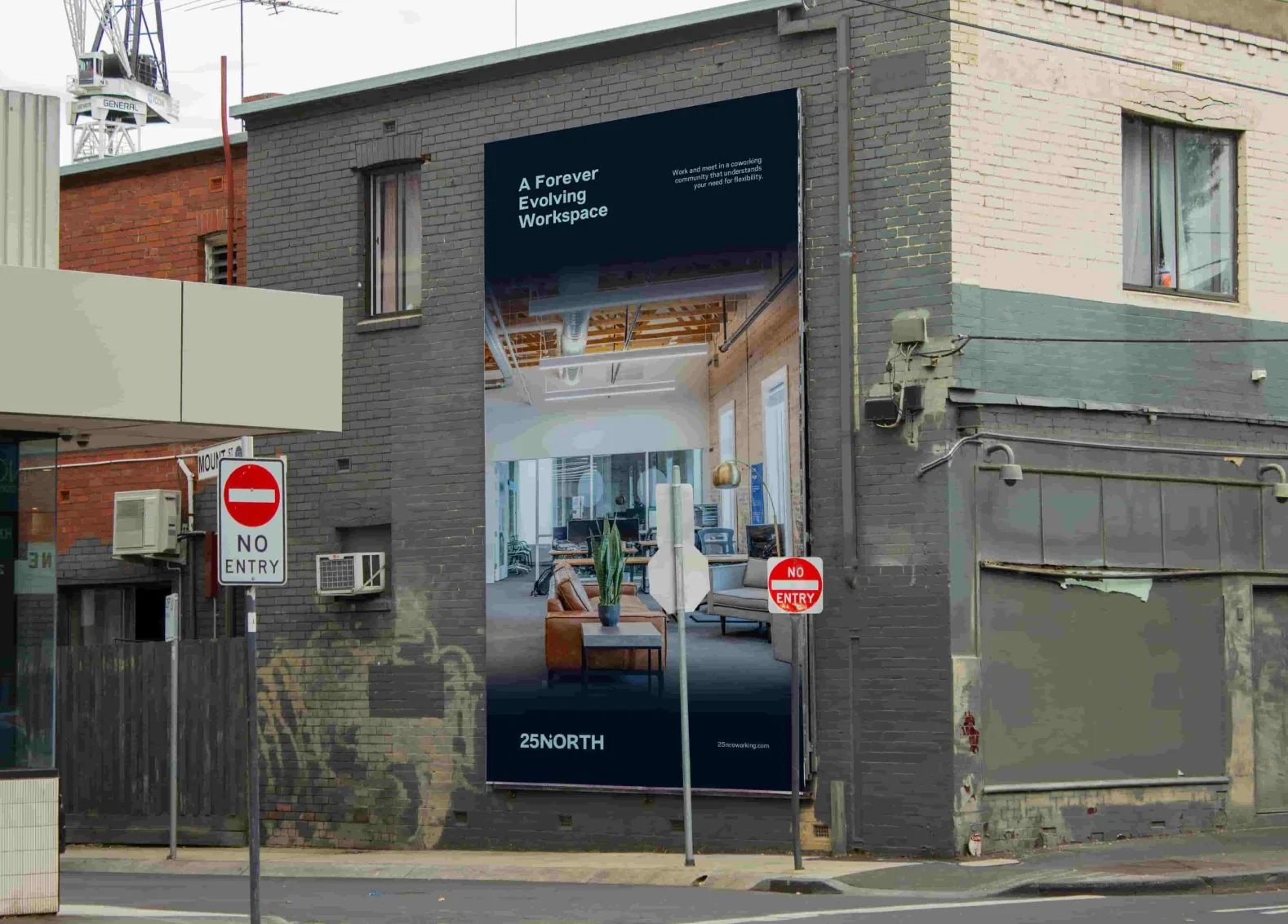 Mural on brick wall of interior office space with furniture and high ceilings