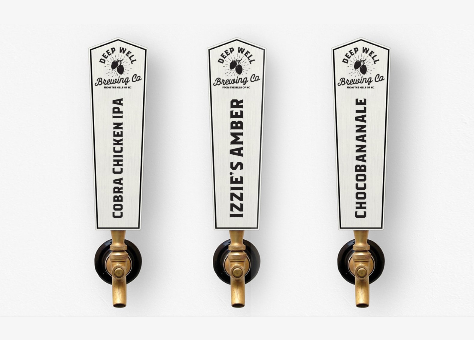 Three beer taps with labels for different beer flavors: Cobra Chicken IPA, Izzie's Amber, and Chocobananaale, mounted on a white wall.