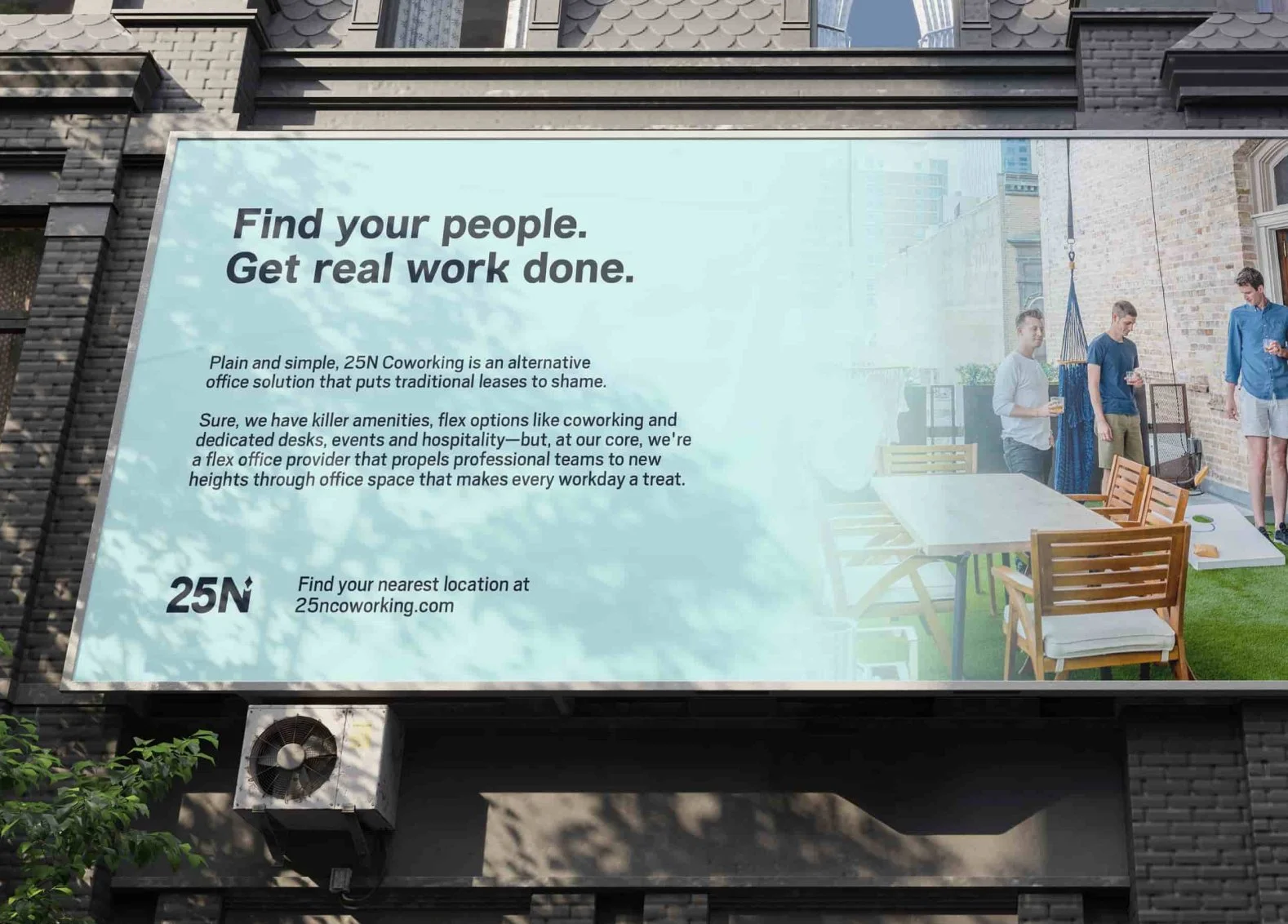 Billboard advertising 25N Coworking, showing a group of people on a rooftop patio with wooden chairs and a table, and a hammock, with tall city buildings in the background.