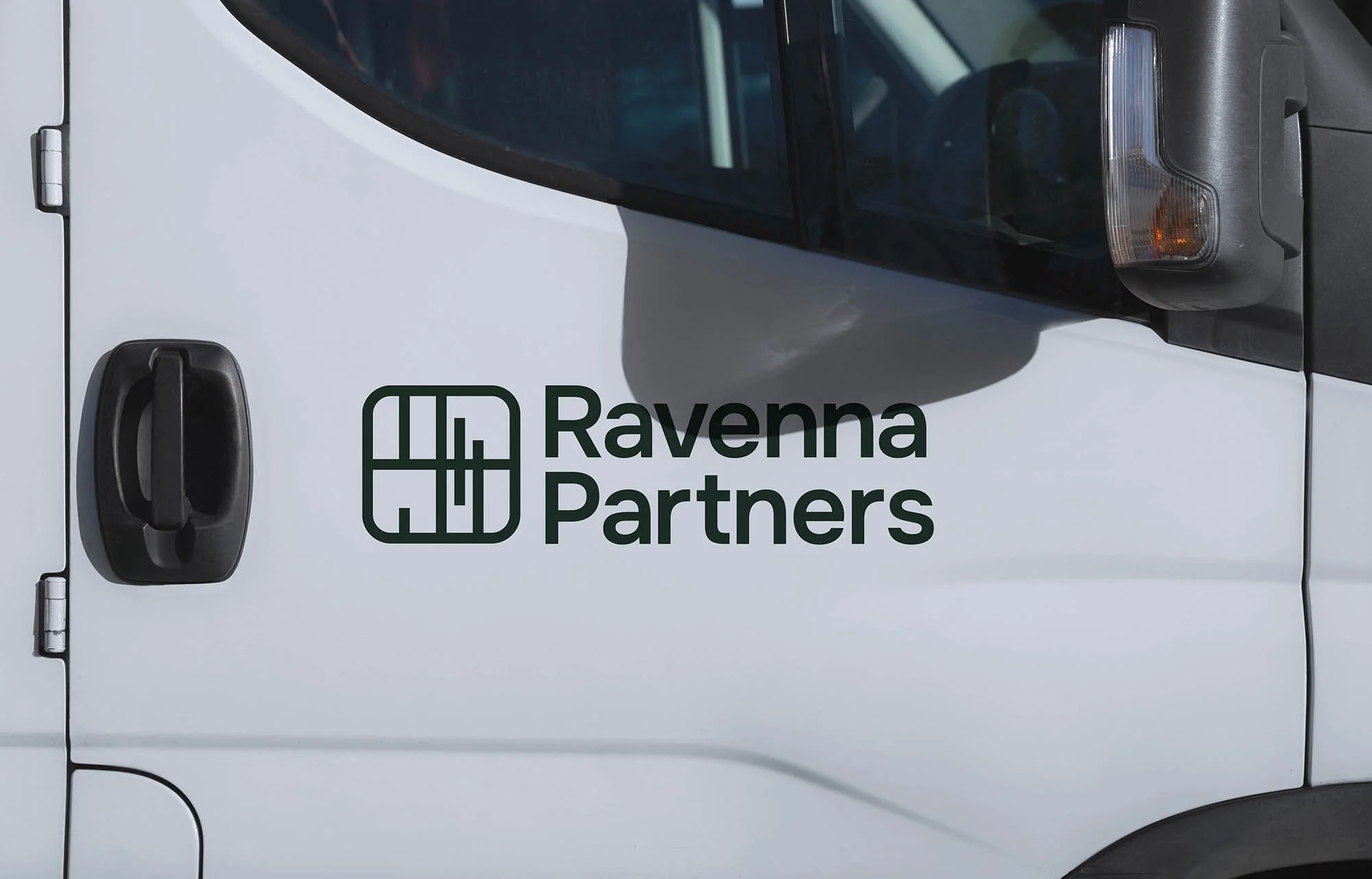 Close-up of a white van with the logo and text 'Ravenna Partners' on the side.