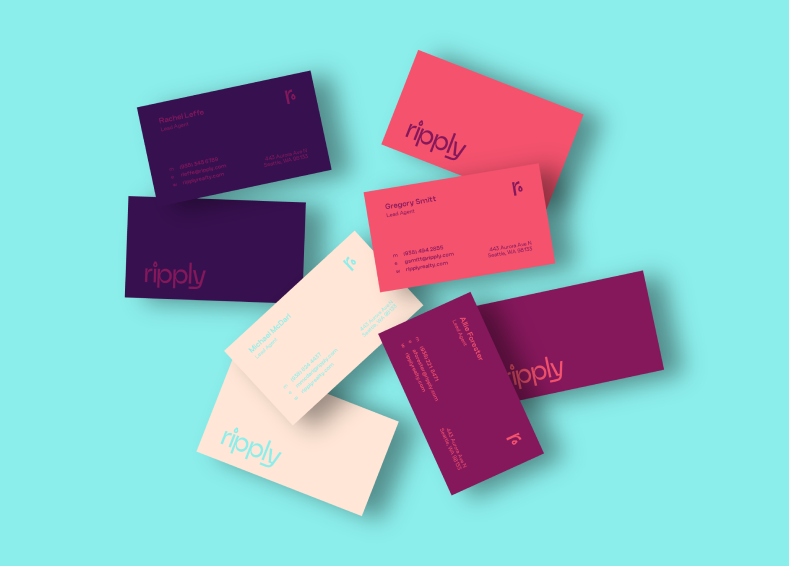 Business cards of different colors and designs, scattered on a light blue background.