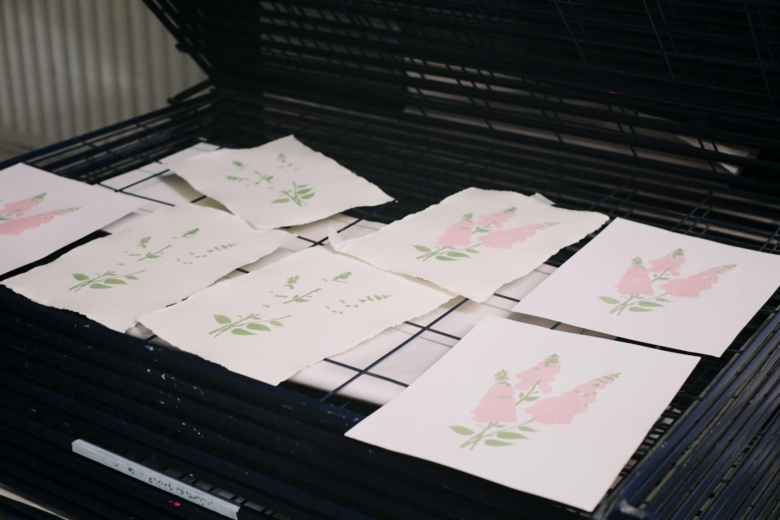 Screen printed foxgloves lying on a studio drying rack