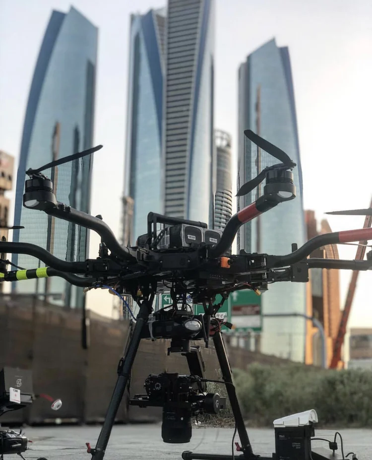 Heavy-lift broadcast drone on its landing pad in front of Abu Dhabi towers