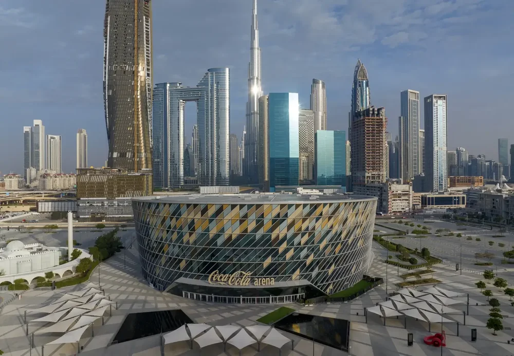 Aerial view of the circular Coca-Cola Arena in Dubai surrounded by towers