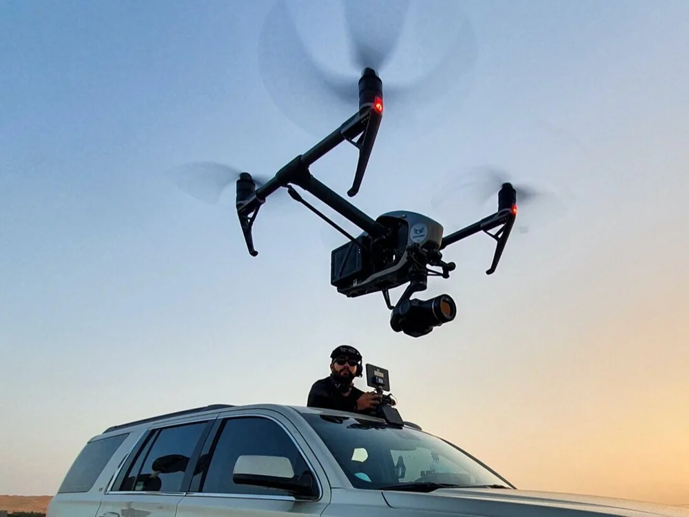 Inspire drone in flight with its operator during the Walk 1000 documentary shoot in Al Dhafra, Abu Dhabi