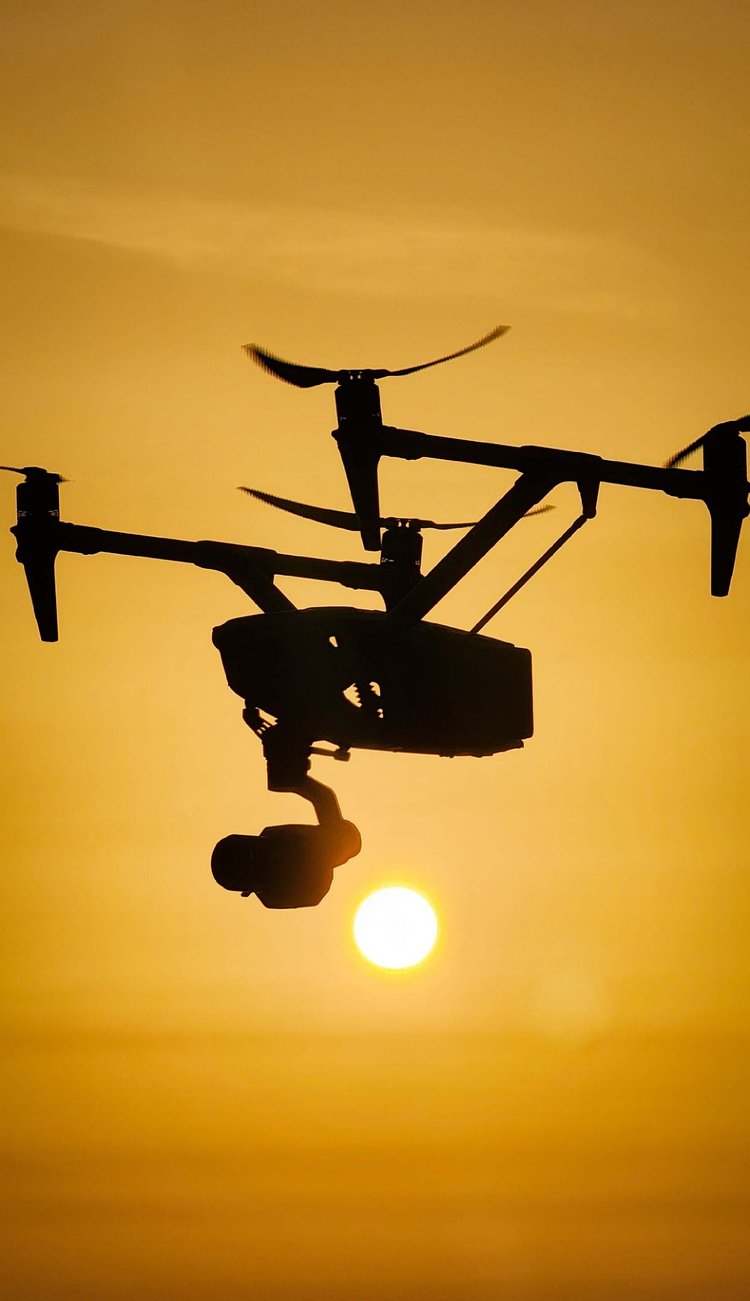 Inspire drone silhouetted against a golden sunset