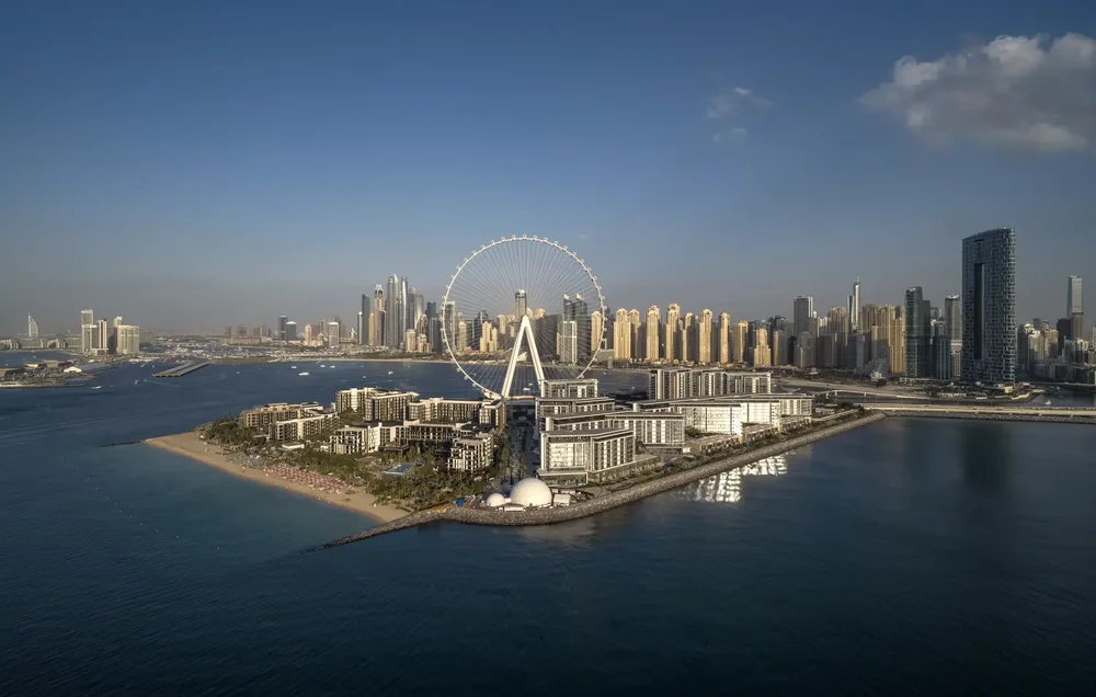 Aerial view of Bluewaters Island and Ain Dubai from the sea with the Dubai skyline