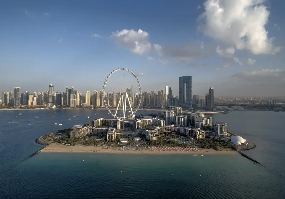 Wide aerial view of Bluewaters Island and the Dubai Marina skyline over the sea