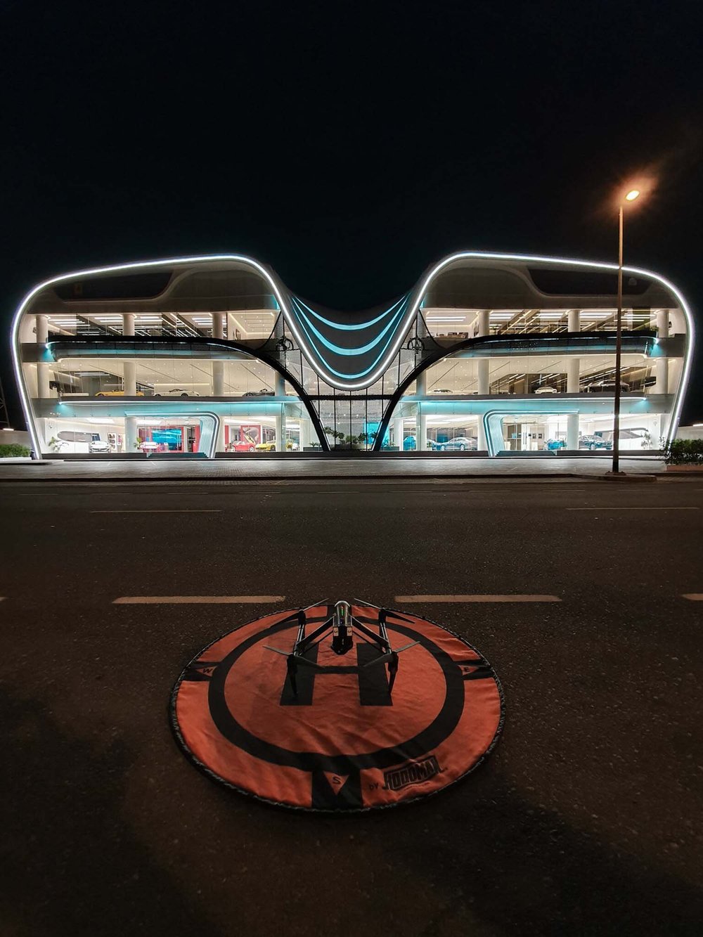 Drone on its landing pad outside a Ferrari showroom in Dubai at night