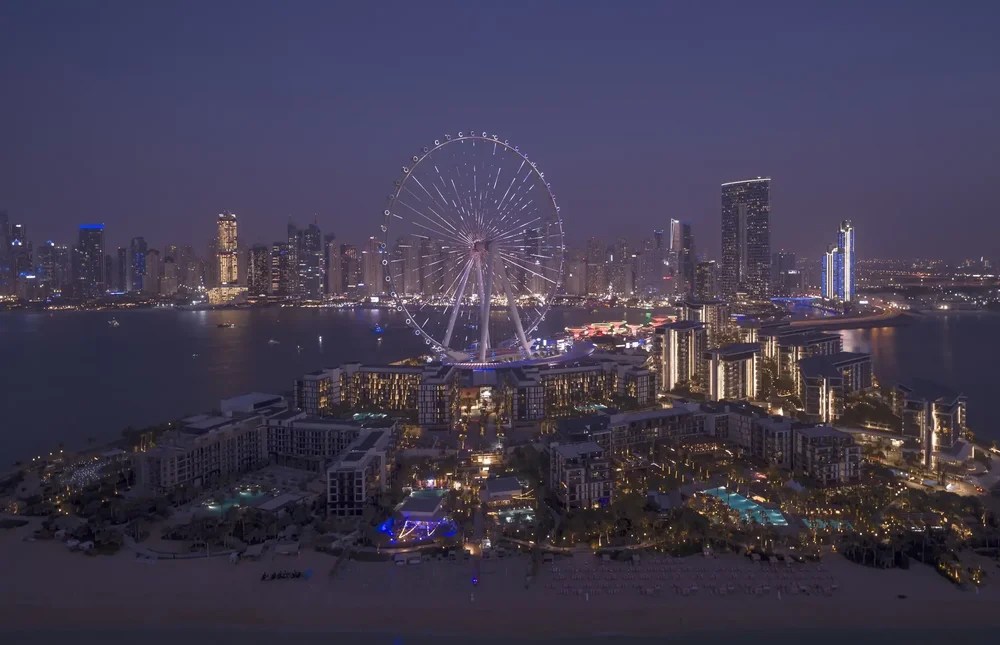 Night aerial photo of the illuminated Ain Dubai observation wheel and Bluewaters Island
