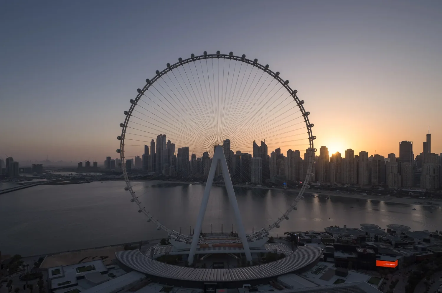 Aerial view of the Ain Dubai observation wheel at sunset with the Dubai Marina skyline behind