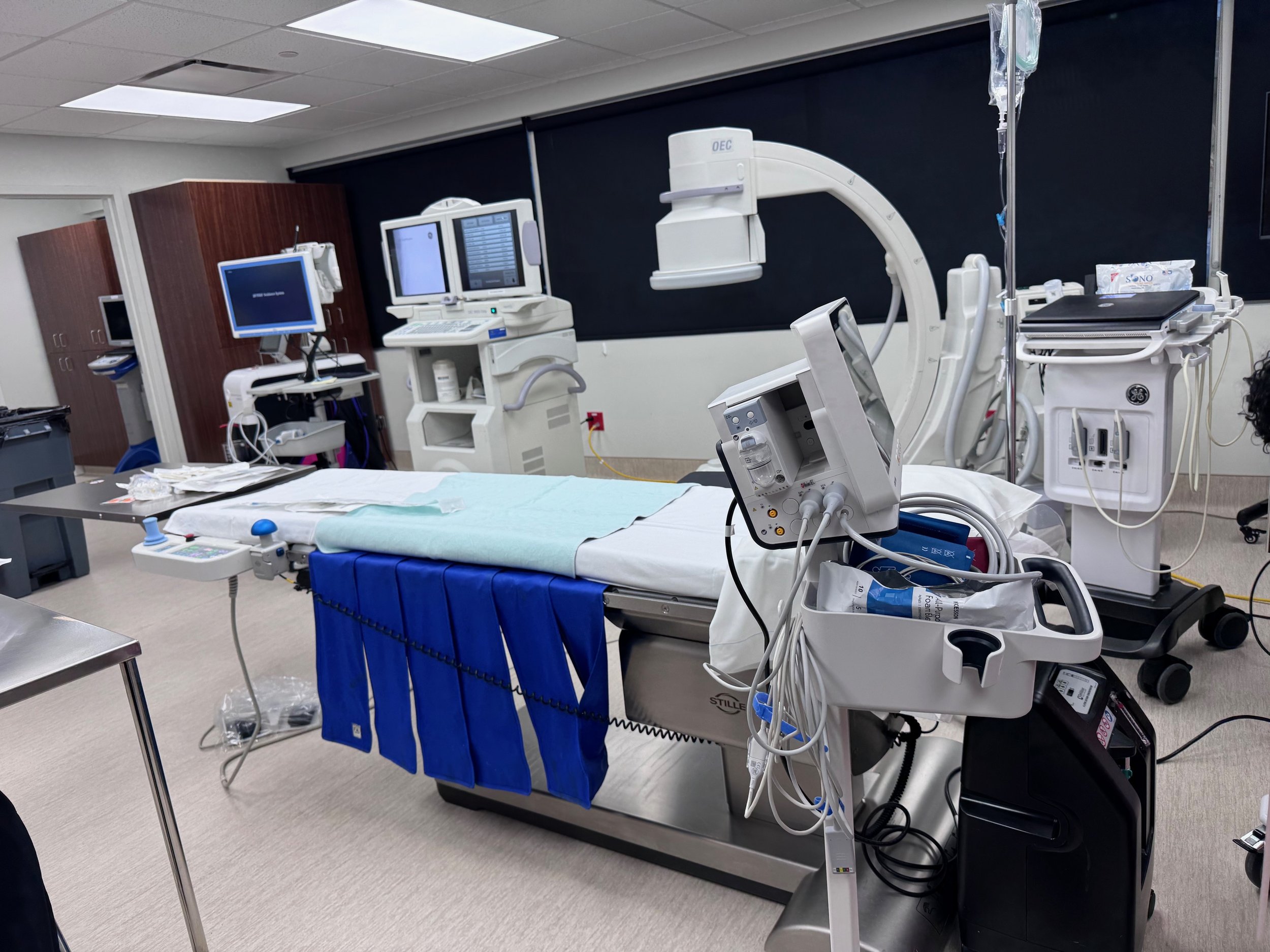 OR table with vitals monitor, C-arm ready.