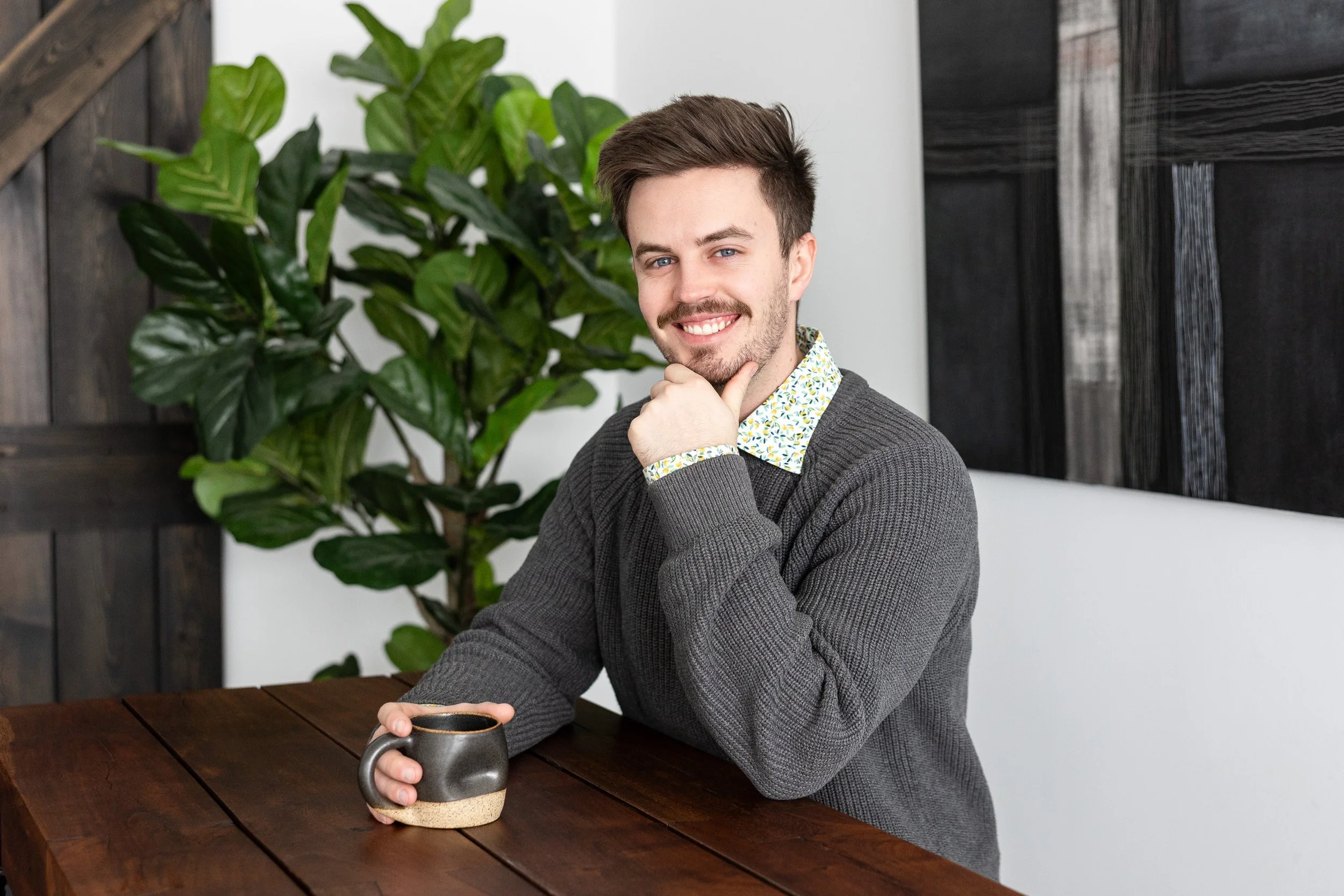 Close-up of dry grasses and plants in a hazy field, with a pale, overcast sky in the background.