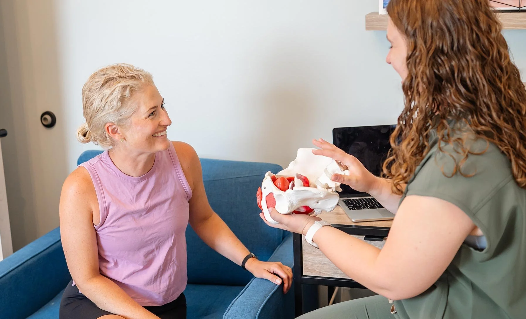 A woman smiles at her pelvic floor physical therapy appointment
