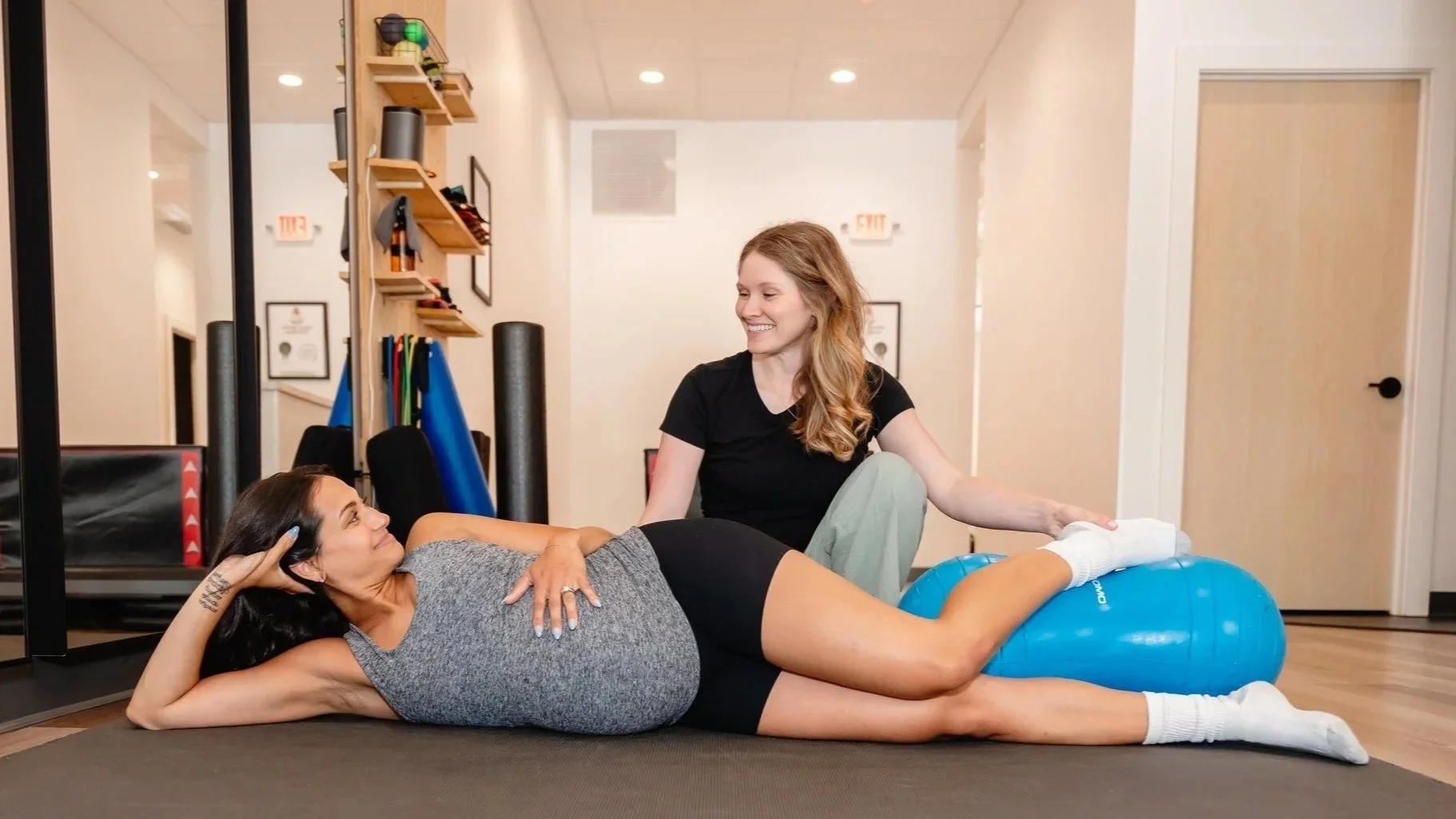 Pelvic floor therapist, Caroline Liu, works with a pregnant woman at Pelvic Health & Wellness in Milwaukee, WI