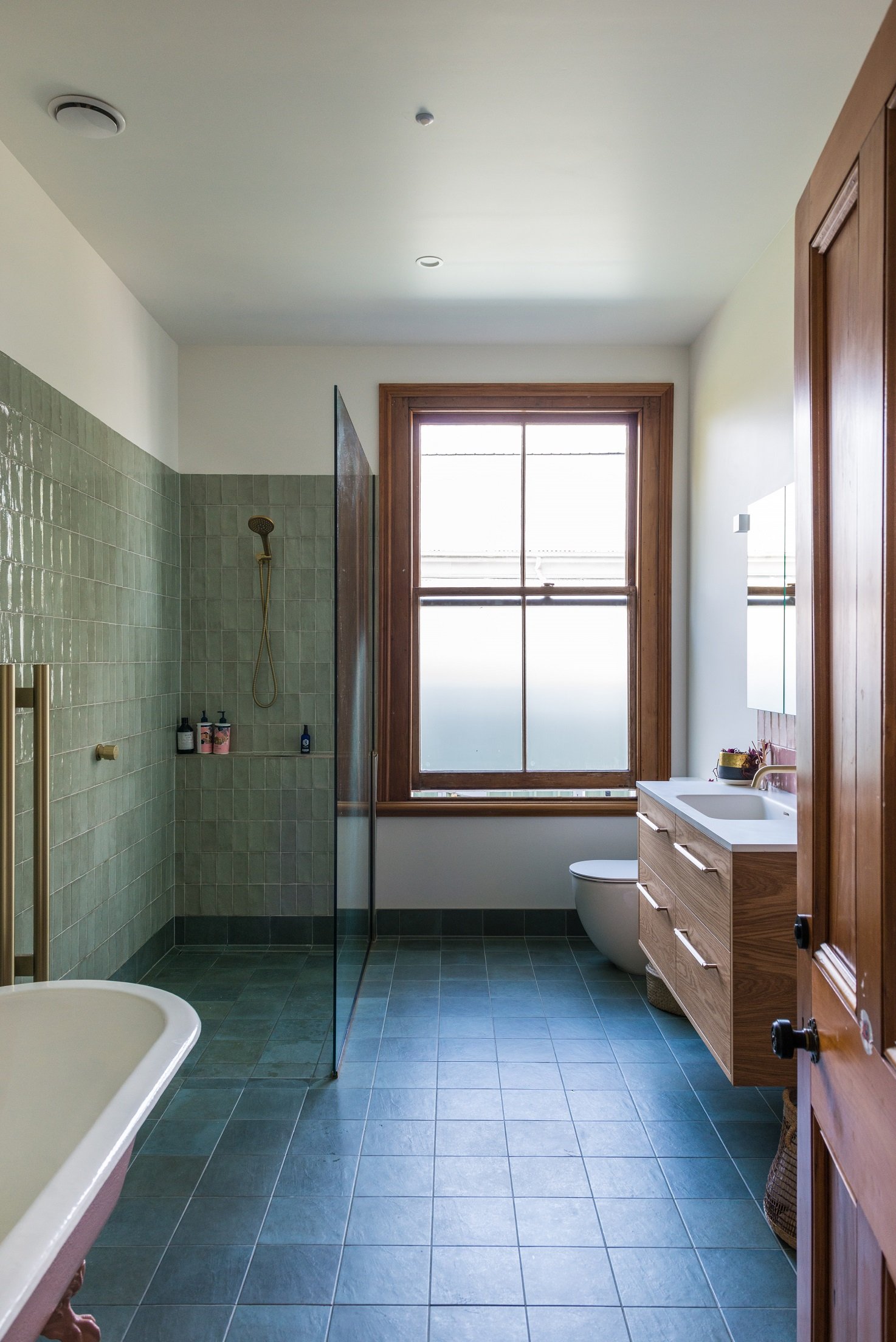 The right materials can make a modern bathroom look perfectly at home in a traditional villa.