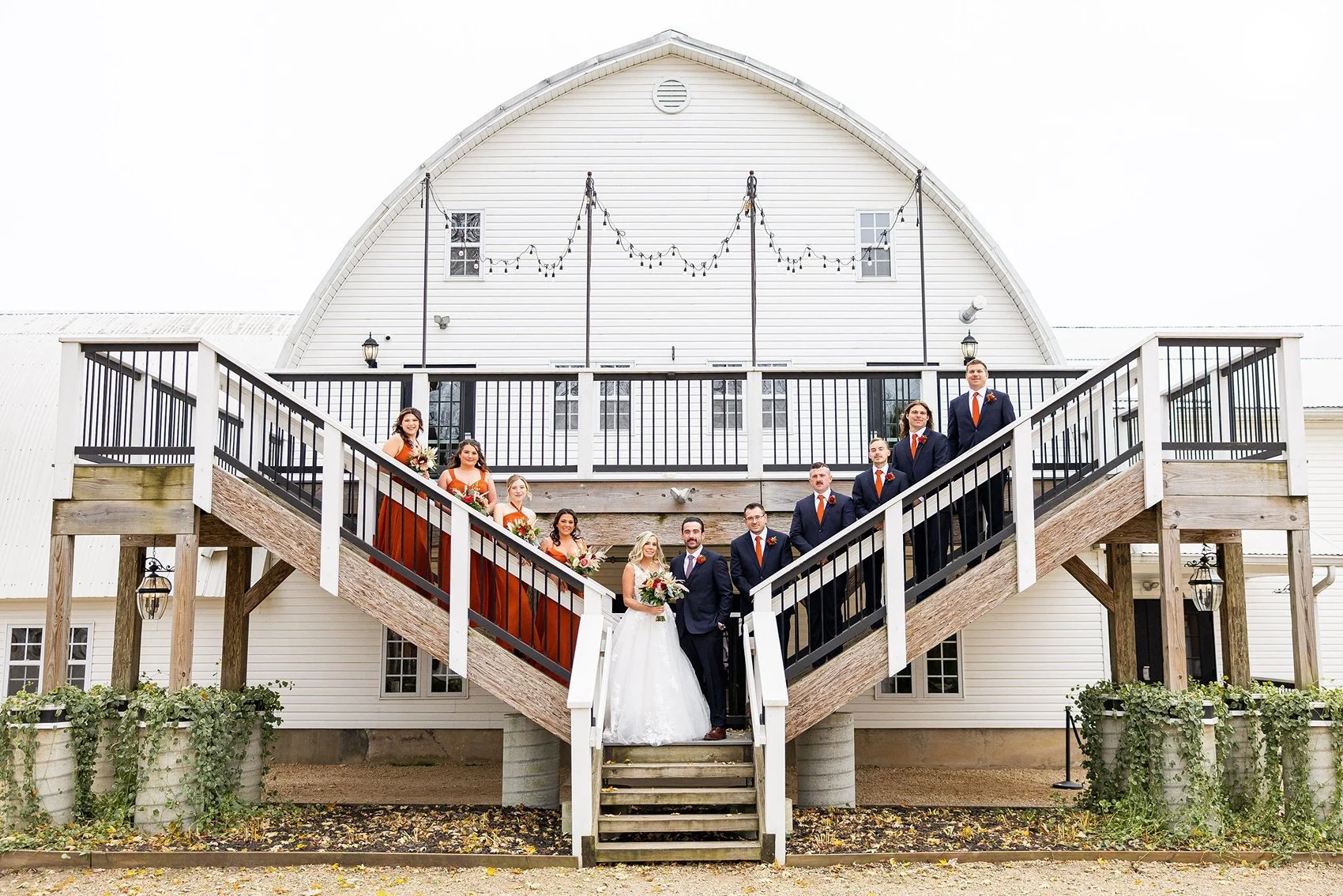 Wedding party portrait at autumn barn wedding venue
