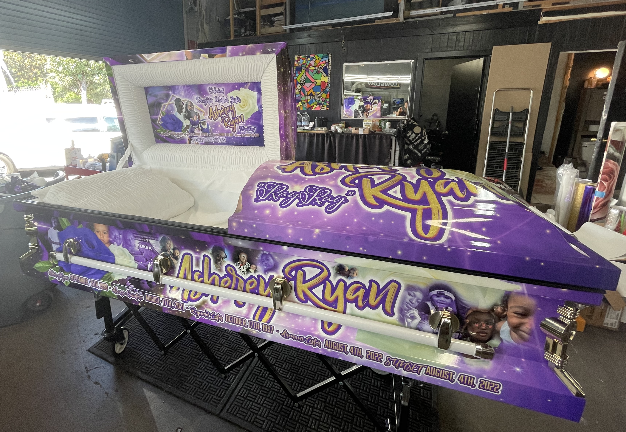 Custom purple casket wrap with decorative graphics and text.