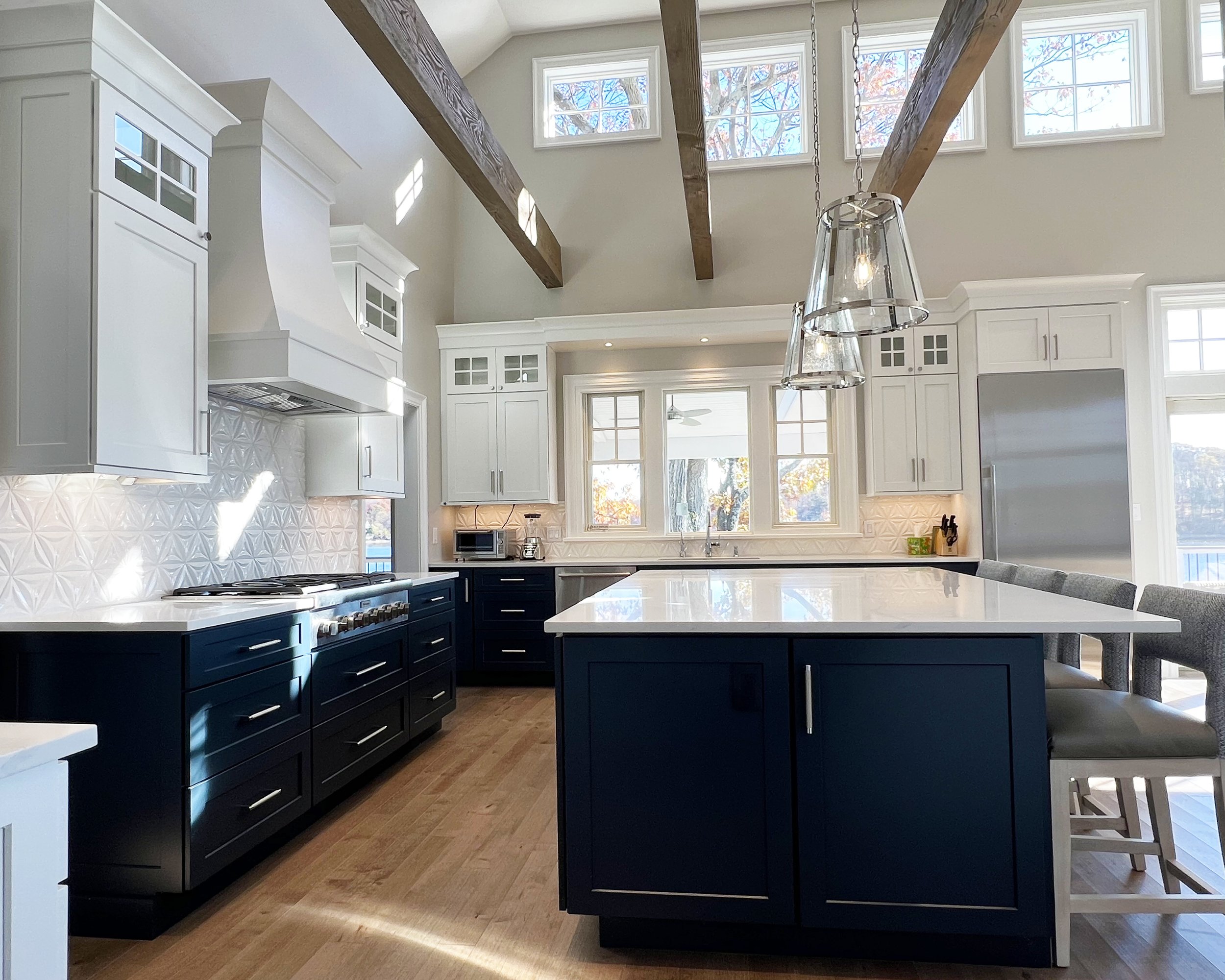 Dark base cabinets and light upper cabinets create a stunning combination.