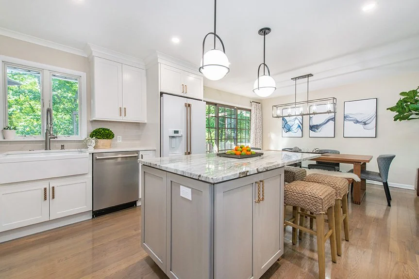 The homeowner does a lot of baking with her children and wanted to be able to put cookie trays directly on the island...so a beautiful 
“fantasy brown” granite was used on the island and the perimeter countertops are quartz. 