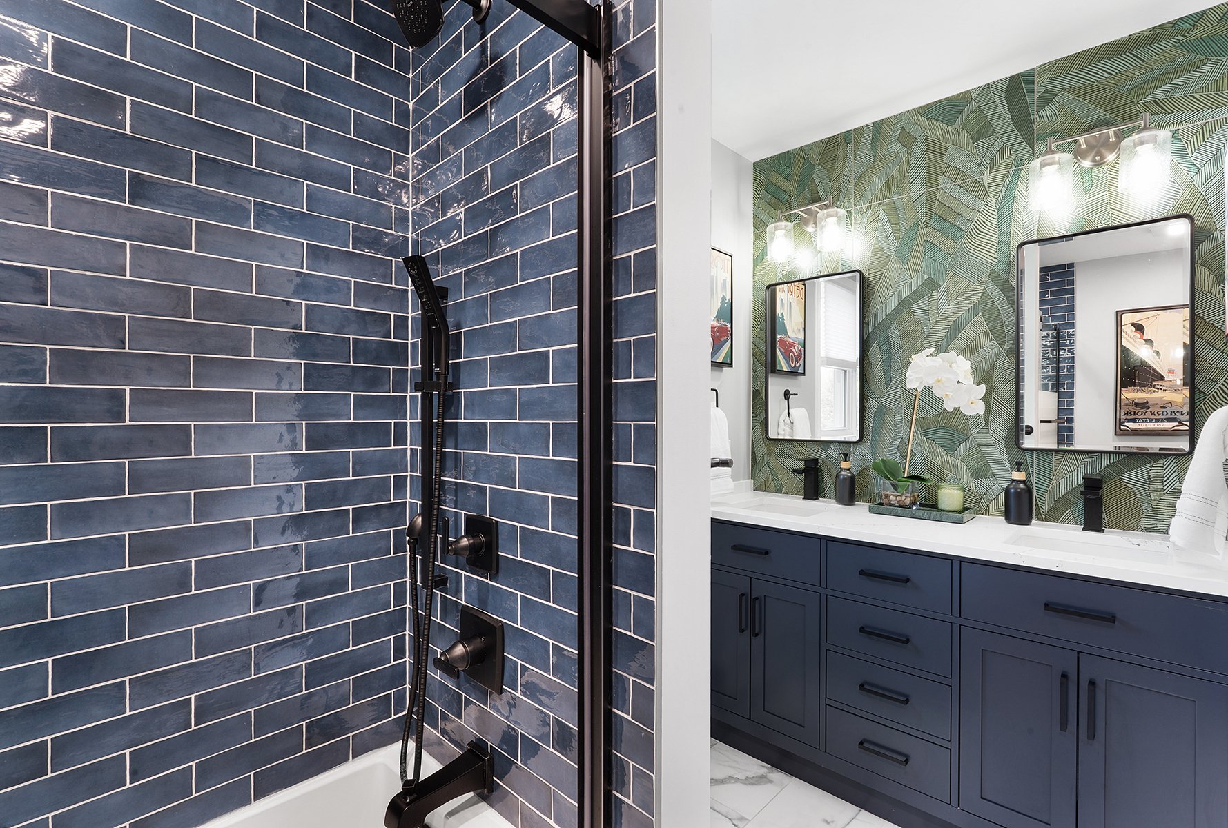 Black hardware provides contrast against the blue subway wall tile and quartz vanity top