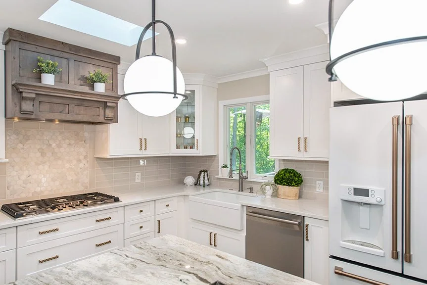 Custom, alder wood hood compliments the white cabinets and grey-glazed finish on the island.