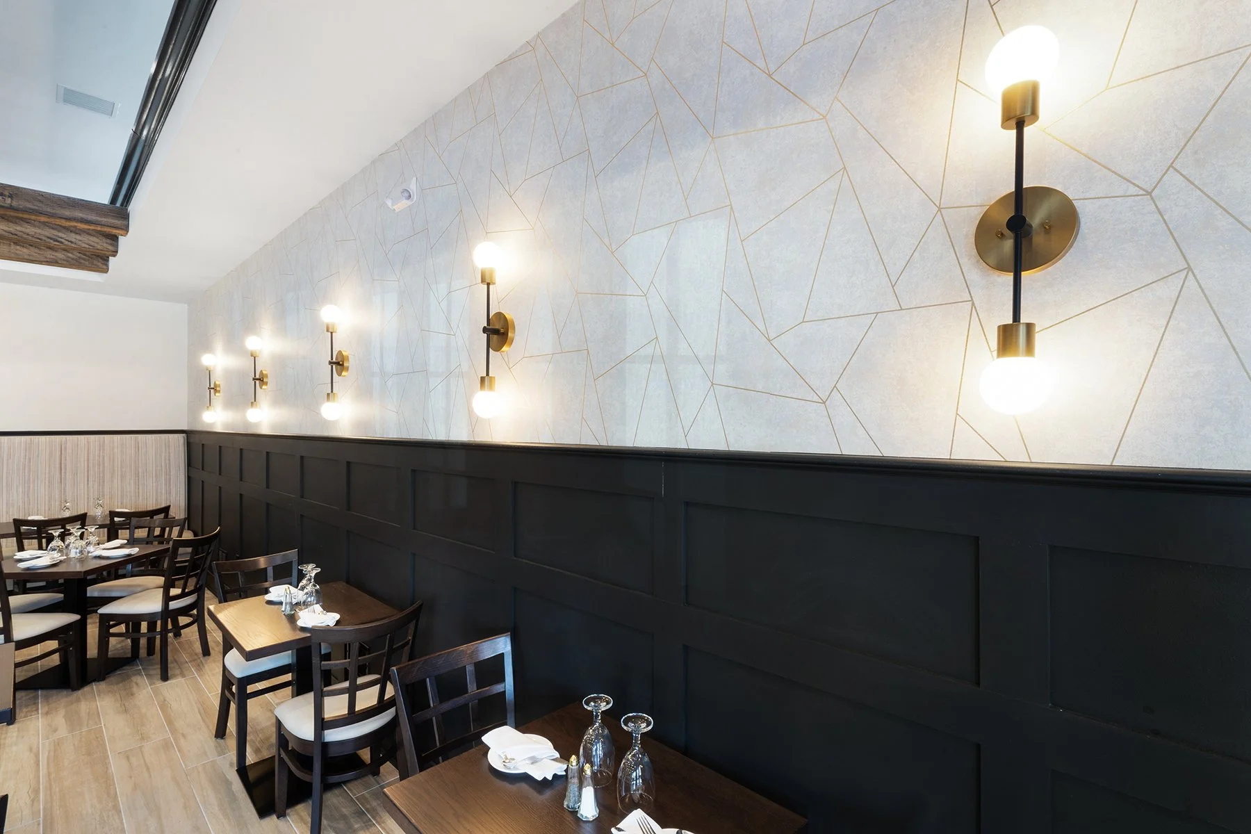 The design choices allowed for a balance of aesthetics, comfortable ergonomics, and seating capacity while giving a unique identity to the long wall. 