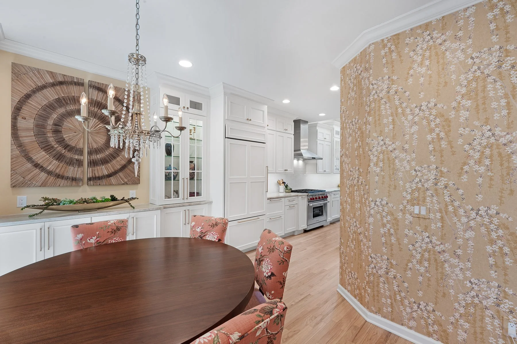 The curved wall—with stunning golden patterned wallpaper—created a smooth flow between the kitchen and dining areas