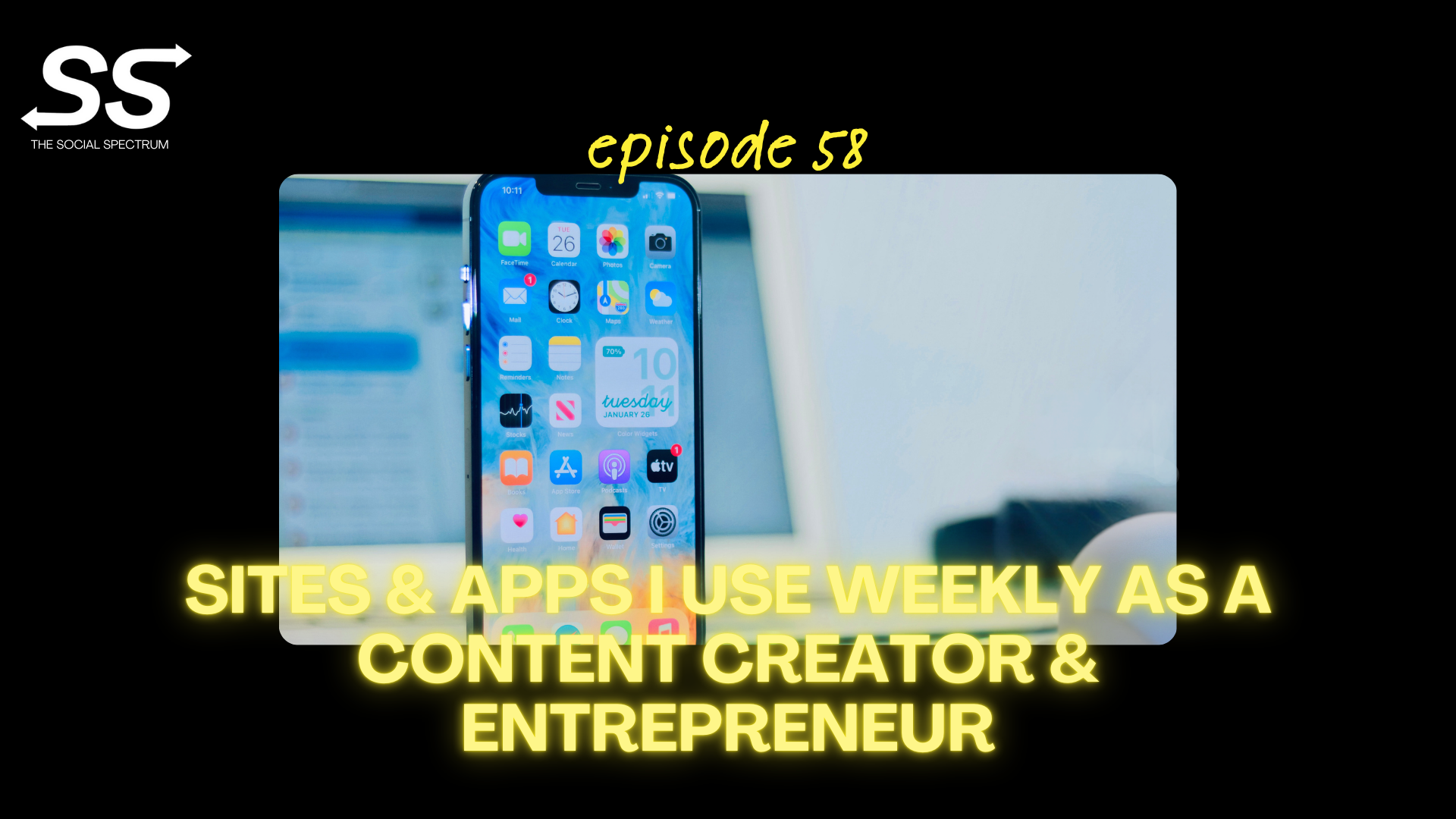 An iPhone, in full focus, propped in front of an open laptop