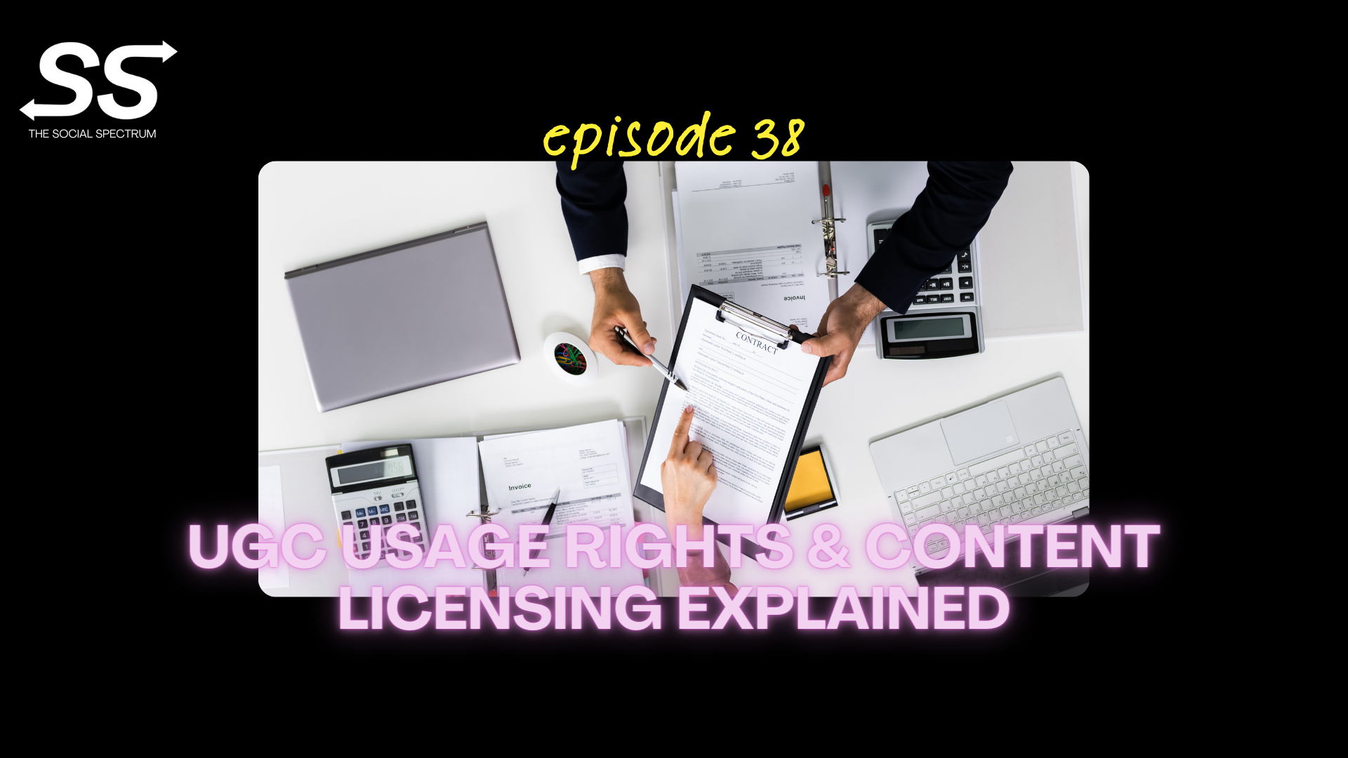 An individual’s hand holding out a clipboard with a contract on it and pointing at something on it with a pen, while another person’s hand points at a paragraph on the contract. A laptop, binder and calculator are scattered around the desk.