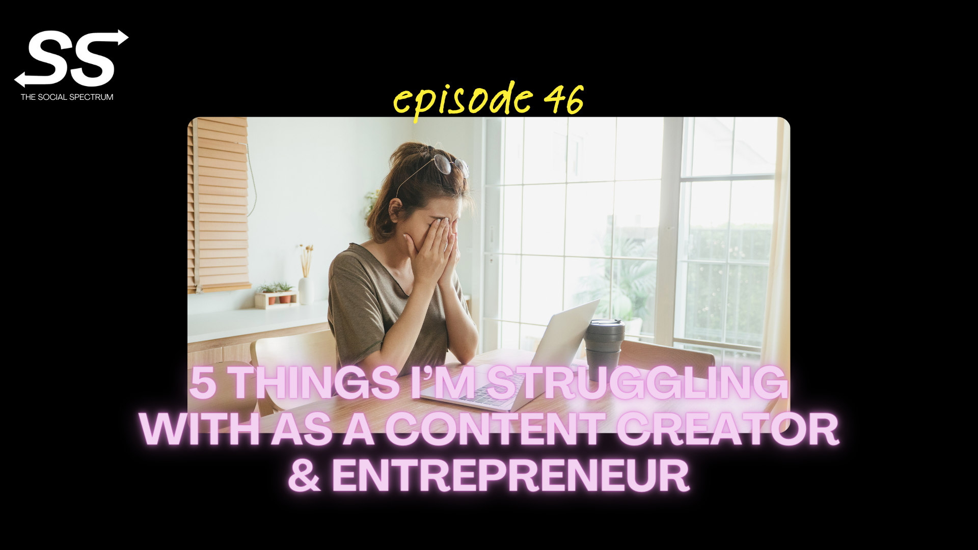 A woman seemingly stressed, covering her face with her hands, while sitting in front of her laptop