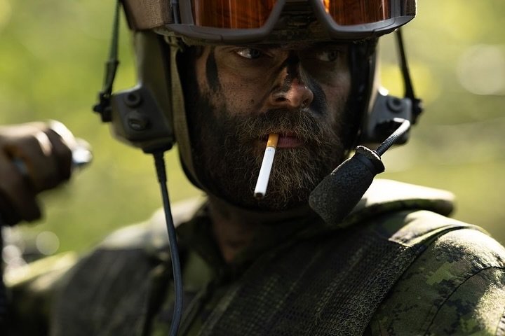 Work by #RUFmember @gjohnjournalism for @globeandmail. 
LAV Commander MCpl Sam Murphy holds a cigarette in his mouth during a pause in the fighting in Estonia during NATO Exercise Spring Storm on May 15, 2024. Murphy, a veteran of the war in Afghanis