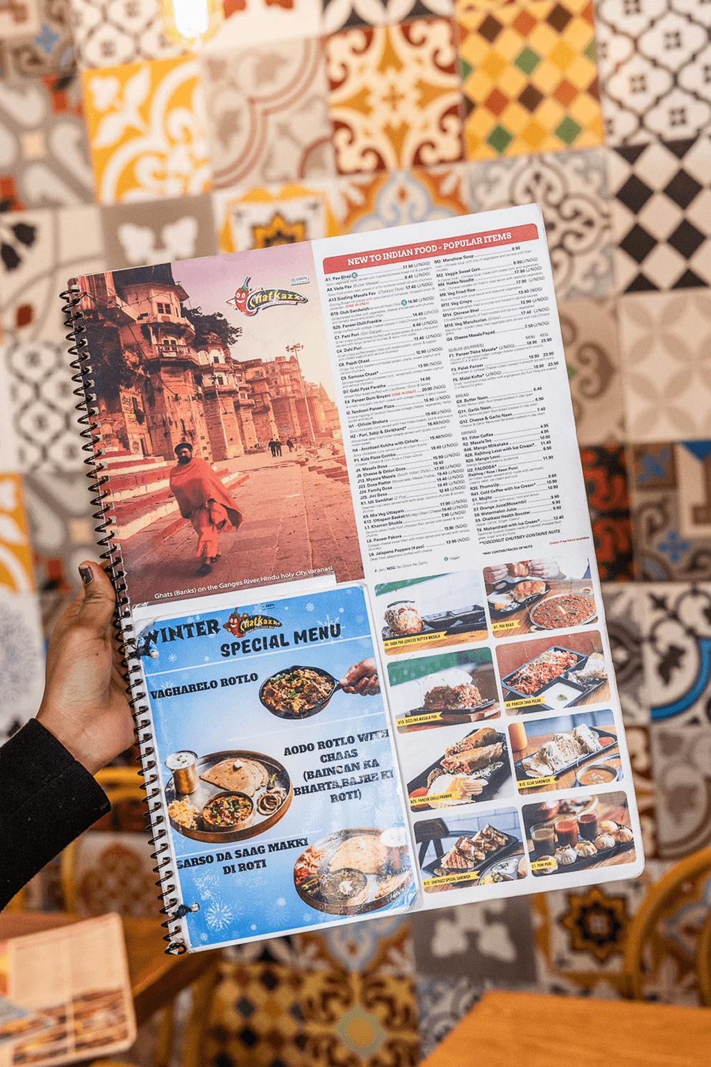 Handheld Chatkazz special menu featuring Varanasi ghats imagery and winter food specials.