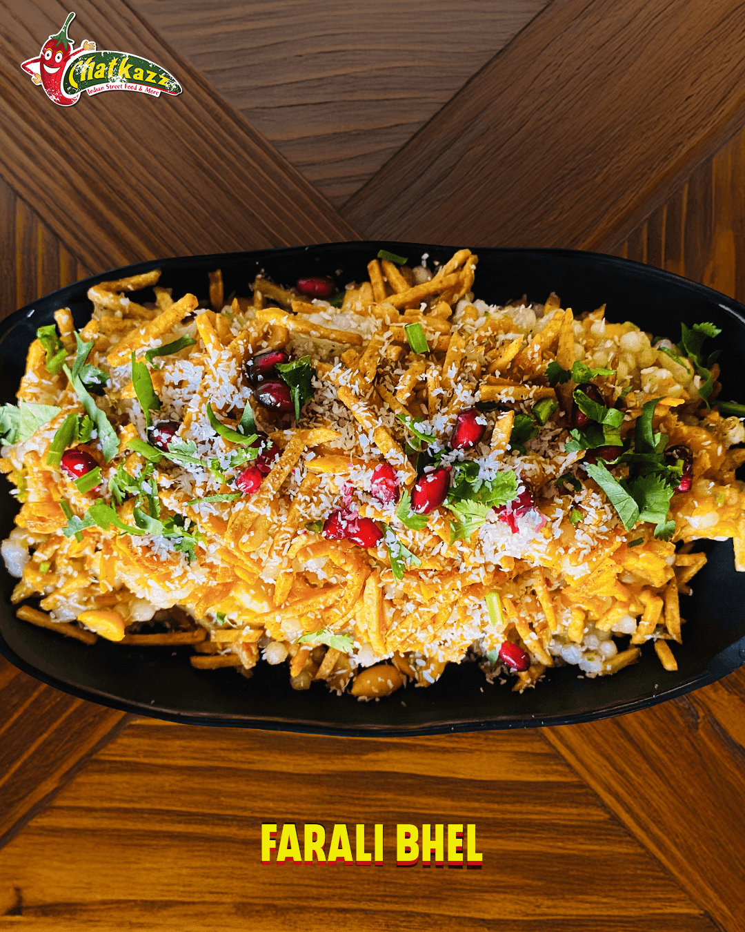 Farali Bhel served in a black platter with crunchy toppings and garnishes, displayed on a wooden table at Chatkazz.