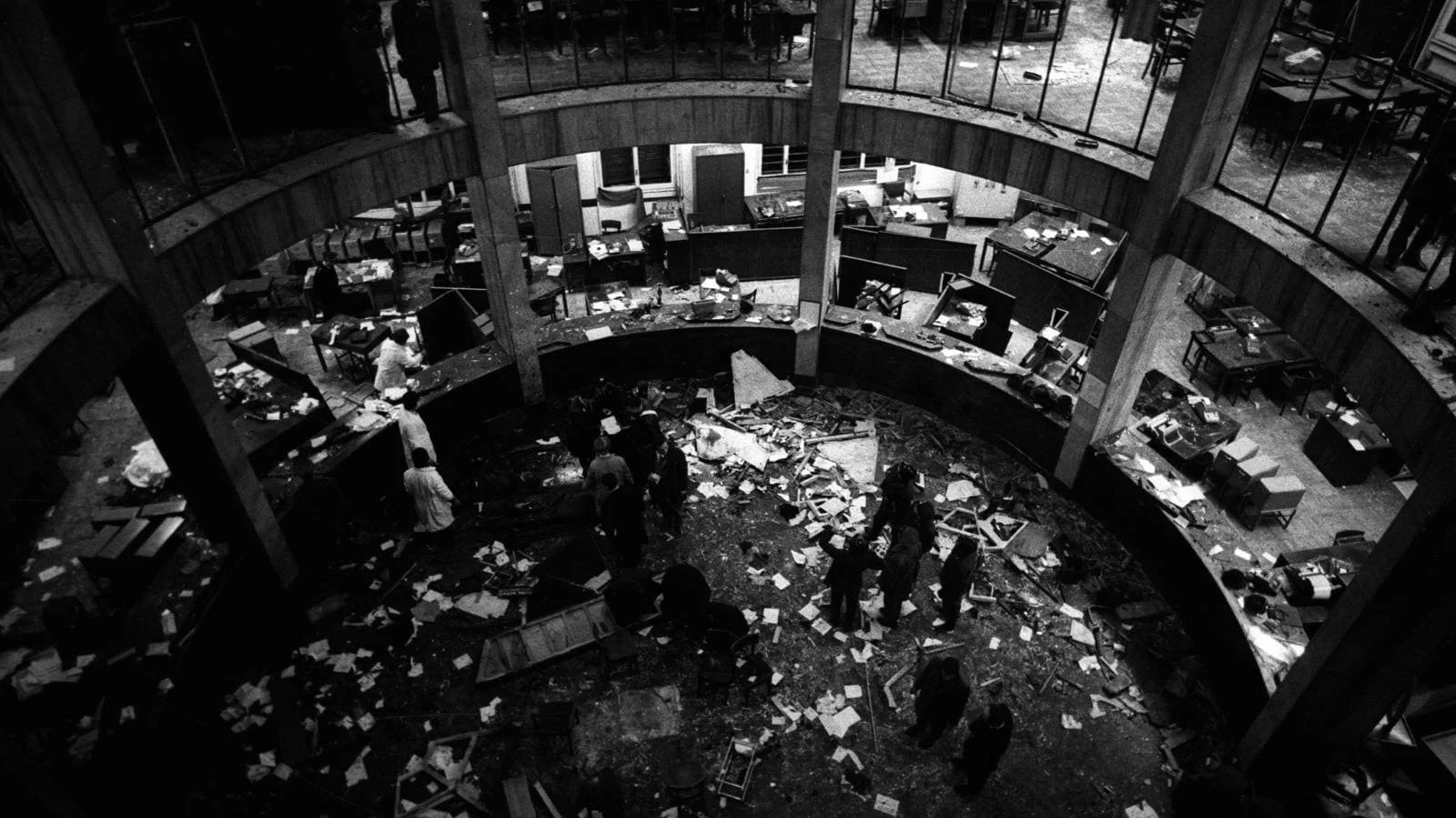 a group of men walking around laying waste to the bank floor