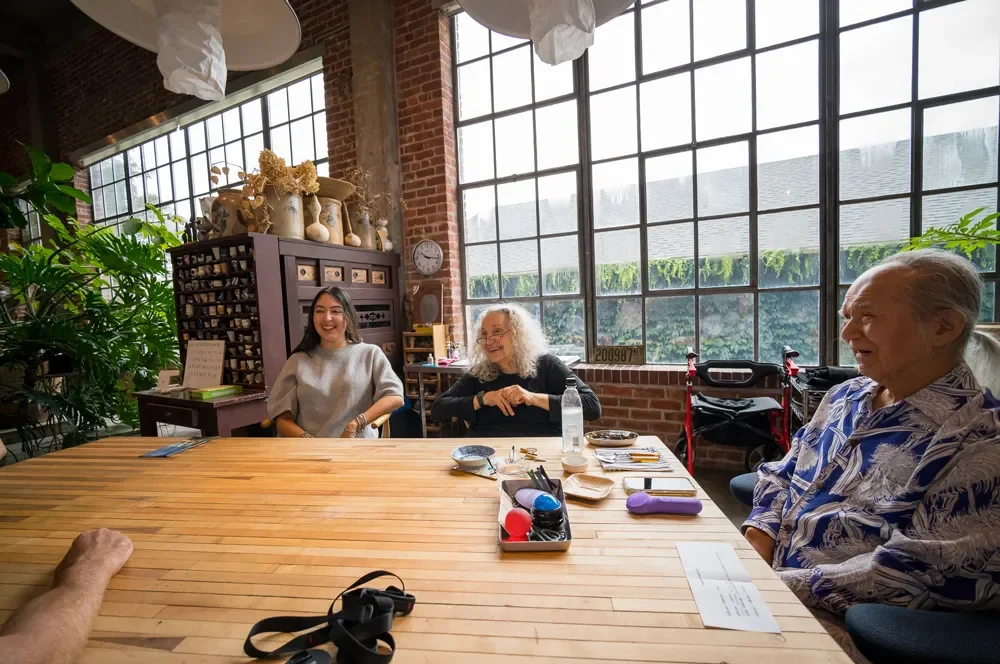 lawrence-anderson-jun-kaneko-meeting-table-discussion.webp