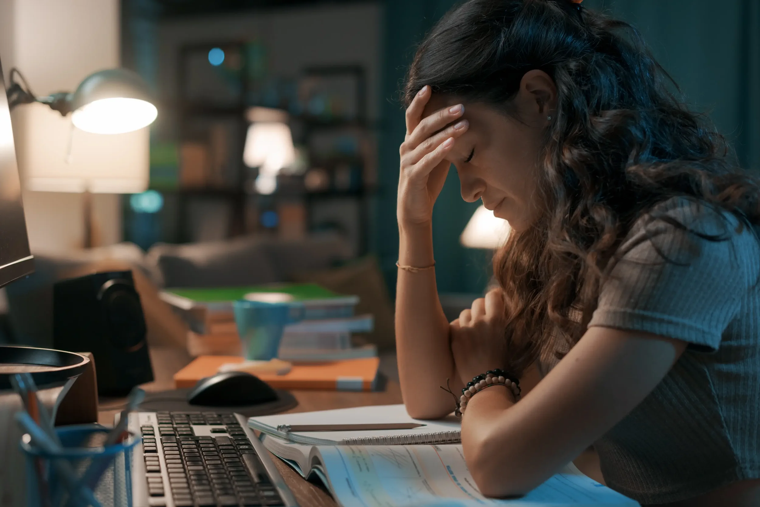 Professional woman experiencing burnout on the floor surrounded by documents